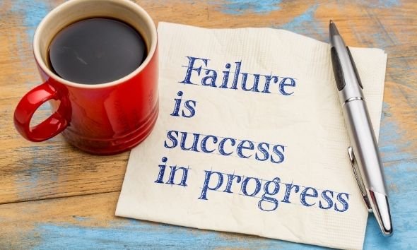  Failure is success in progress and part of overcoming challenges-handwriting on a napkin with a cup or of coffee.