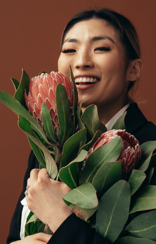Woman happily holding flowers.