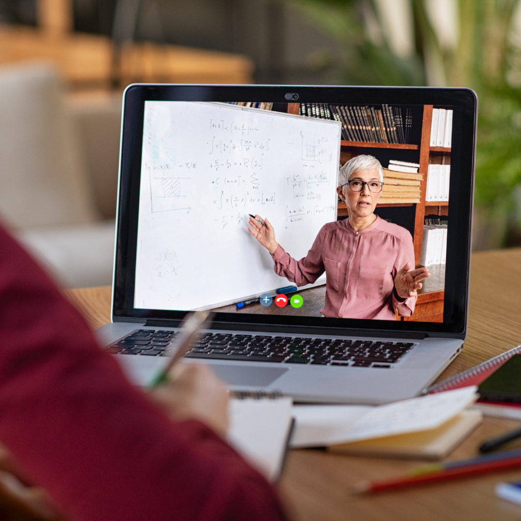 Student watching an online course business owner teach a course.